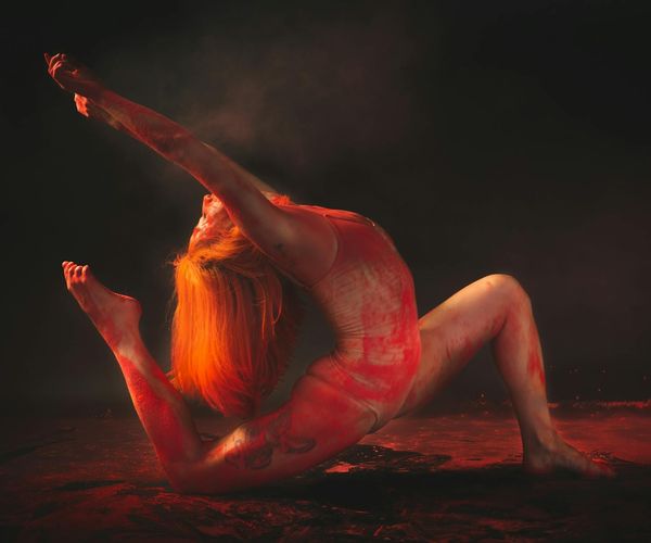 Person performing a dynamic yoga stretch on a mat.